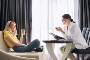 Female psychologist counseling teenage girl in office