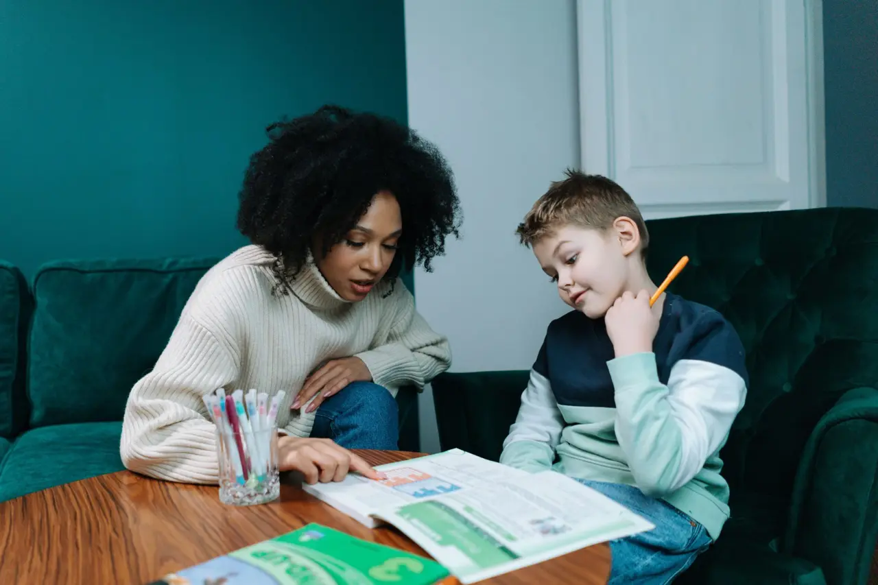 A clinician working through a reading task with a boy
