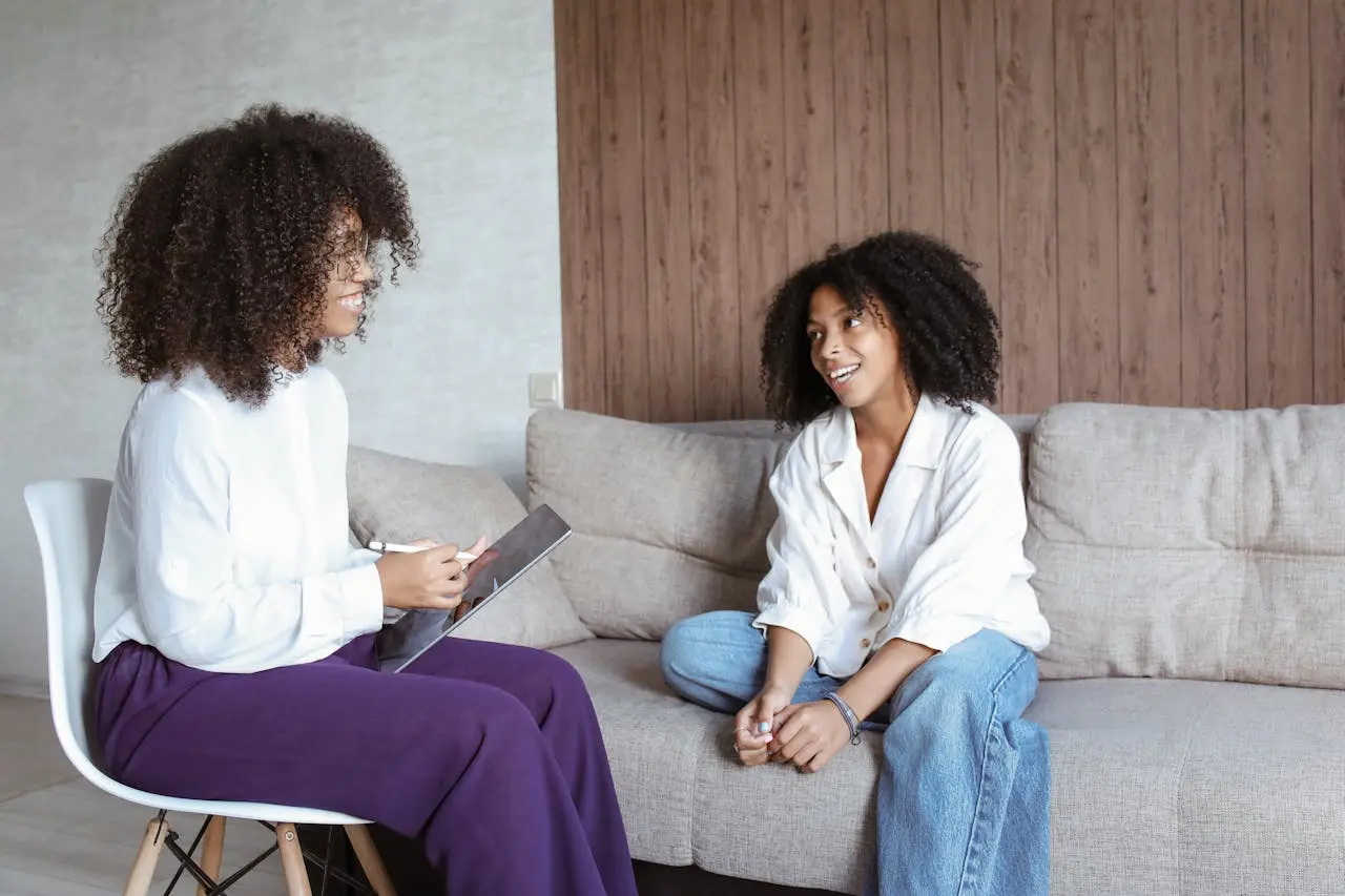 A teen talking with her counselor on a couch